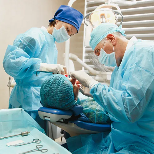 dentists using dental tools in patient's mouth