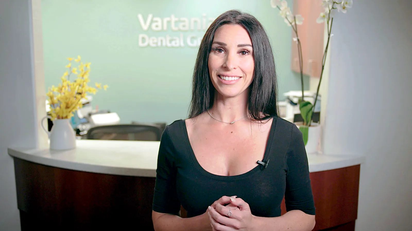 Thumbnail of a woman smiling at a dental office.