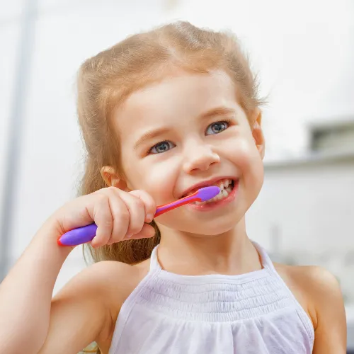 Young girl brushing her teeth.