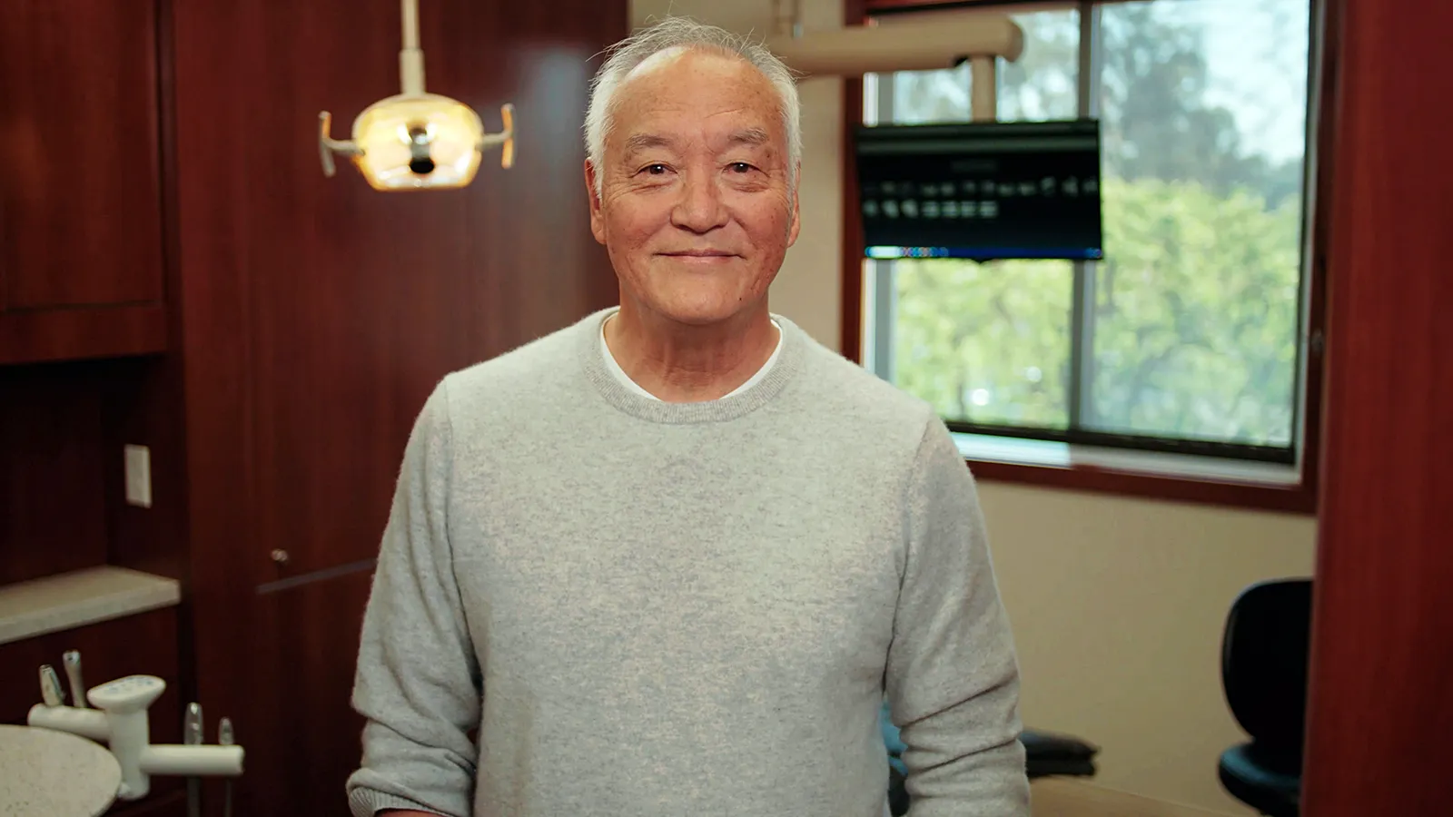 Thumbnail of an older man posing in a dentist’s office.